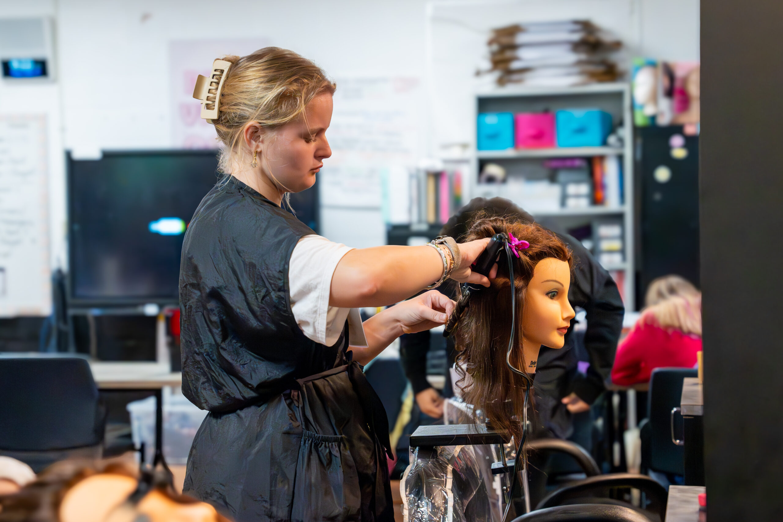 Photo of a Young Professional learning her craft in the Cosmetology Program