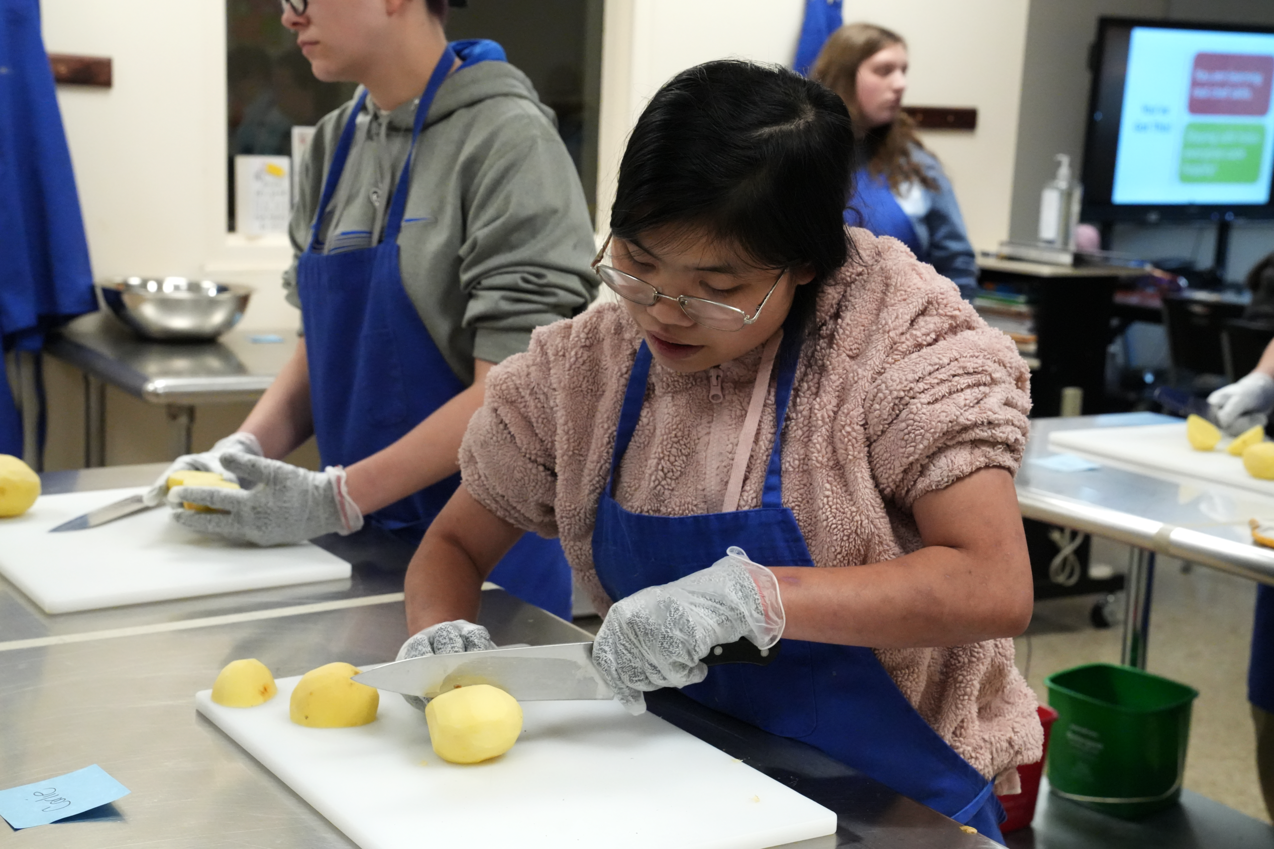 Photo of Young Professionals working in the kitchen. The kitchen is their classroom.